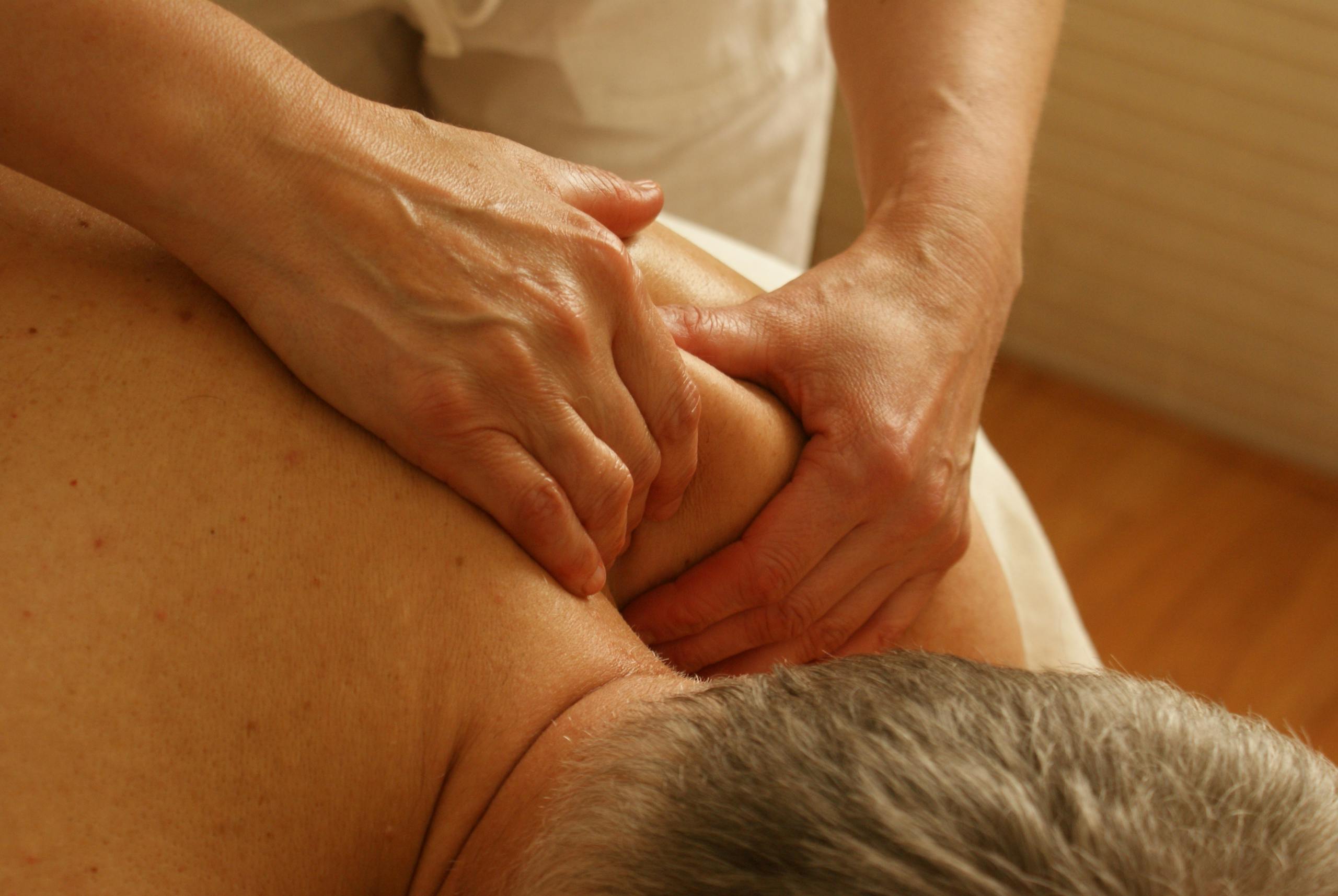 Close-up of a therapist giving a relaxing shoulder massage, enhancing wellness and stress relief.